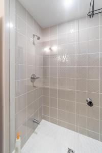 a bathroom with a shower with a glass door at Beautiful New Townhouse in Quiet Neighbourhood in Ajax