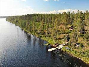 an aerial view of a river with houses and trees at Lomamökki Kuhmo, Tervatörmä in Kuhmo +38 photos