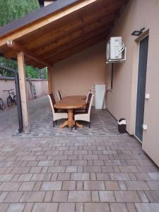 a wooden table and chairs on a patio at Vikendica Nika in Palić +25 photos