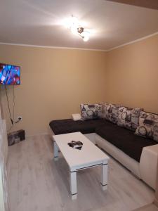 a living room with a couch and a table at Vikendica Nika in Palić