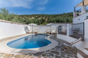 a swimming pool in the backyard of a house at Casa Valle de Oro in Villanueva de Algaidas