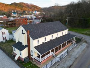 an aerial view of a white building with a black roof at The Tellico Plains Inn and Event Venue in Tellico Plains