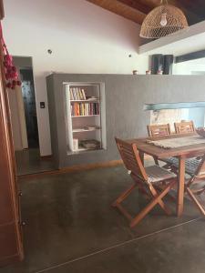 a dining room with a wooden table and chairs at Casa de fin de semana El Ancla in Campos Salles