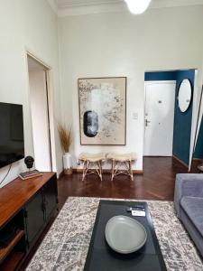 a living room with a couch and a tv at Buenos Aires, Recoleta, Capital Federal in Buenos Aires