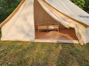 a tent with a bed inside of it at Tipi Camping in der Mecklenburgischen Seenplatte in Carpin