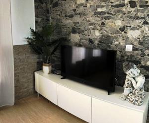 a flat screen tv sitting on top of a white cabinet at Apartamento Casa el Canario in Costa Teguise