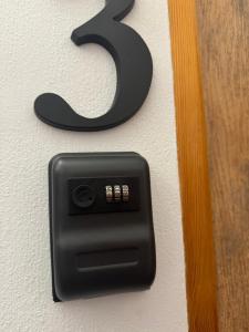 a black outlet with a number on a wall at Rynek Pokoje Paris -Parking in Kielce