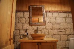 a bathroom with a wooden sink and a mirror at Alaçatı Kavalalı Otel in Alaçatı +48 photos