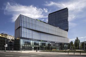 a tall glass building with a lot of windows at Ibis Styles Wroclaw Centrum in Wrocław