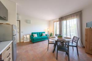 a kitchen and a living room with a table and chairs at Vistaverde Harmony Apartments in Cavaion Veronese