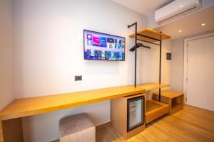 a room with a desk and a tv on the wall at Absolute Hotel Ksamil in Ksamil