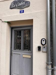 a door to a building with a sign above it at Studio cocooning à Cauterets 2 adultes et 1 enfant in Cauterets