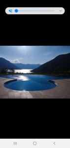 a screenshot of a webpage with a picture of a lake at Pool and spa apartment 1BR in Donji Morinj
