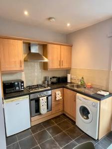 a kitchen with a washer and a dishwasher at Central, Stylish, & Modern Flat in Belfast