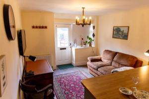 a living room with a couch and a table at The Bothy in Dundee