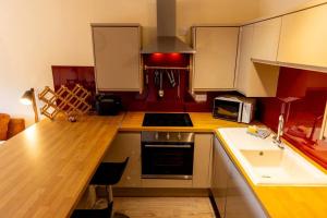 a kitchen with a counter and a stove top oven at The Bothy in Dundee