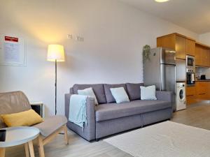 a living room with a couch and a kitchen at Villa Boas House in Castro Daire