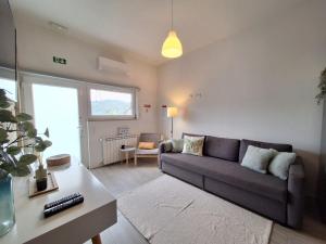 a living room with a couch and a table at Villa Boas House in Castro Daire