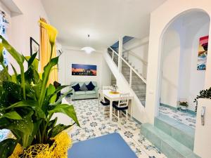 a living room with a staircase and a table at Blue Apartment in Ischia