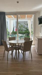 a dining room with a table and chairs at Ancora Resort in Acciaroli