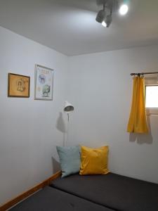 a bedroom with a bed with a yellow curtain at Ostoja Lipiny 