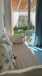 a bed in a room with a view of a patio at Ancora Resort in Acciaroli