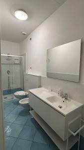 a bathroom with a white sink and a toilet at Ancora Resort in Acciaroli