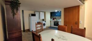 a kitchen with a table and chairs and a white refrigerator at Grand Studio 52 in Faro +13 photos