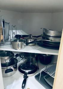 a bunch of pots and pans on a shelf in a kitchen at Modern Upper Level Duplex House in Slave Lake