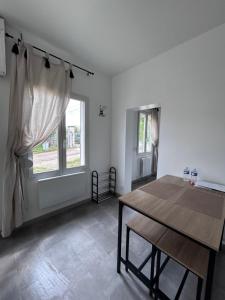 a dining room with a table and a window at La petite maison in Brienon-sur-Armançon