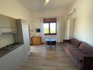 a living room with a couch and a table at Appartamenti in Villa Calamoni in Favignana