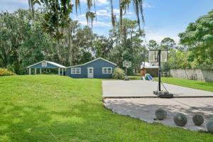 a woman is playing basketball on a basketball hoop at Cozy River Cabin Family Friendly Dock Playset Bball Court in Clay Landing