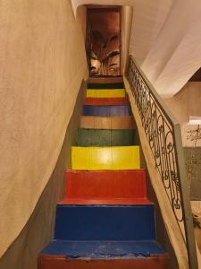 a set of stairs with colorful paint on them at Medina Oasis Hostel in Marrakech