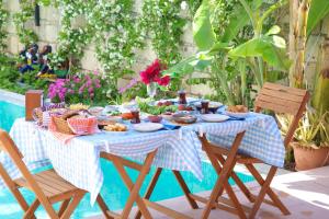a blue and white table with food and chairs at Wind Of Alaçatı Adult Only 13 in Çeşme