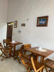 a dining room with wooden tables and chairs at Casa del Viajero in Villa de Leyva