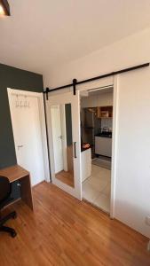 a room with two sliding doors and a kitchen at Estúdio a 500m Metro Joao Dias in Sao Paulo