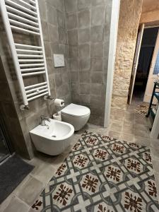 a bathroom with a toilet and a sink at Holiday Home Cosimo in Locorotondo