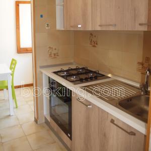 a kitchen with a stove top oven next to a sink at InternoUno in Diamante +13 photos