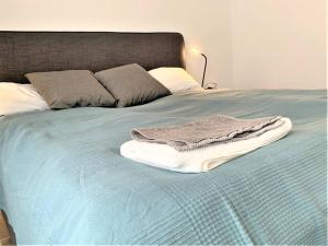 niebieskie łóżko z ręcznikami na górze w obiekcie Stilvoll eingerichtete Wohnung in Essen-Südviertel w Essen