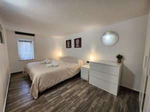 a bedroom with a bed and a dresser and a mirror at Don Vito's Home, DsG2 Short Lets, 250 mt Metrò in Palermo
