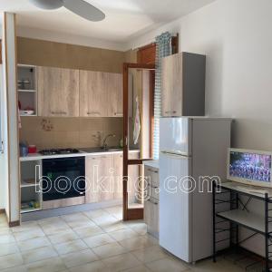 a kitchen with a refrigerator and a table in it at InternoUno in Diamante