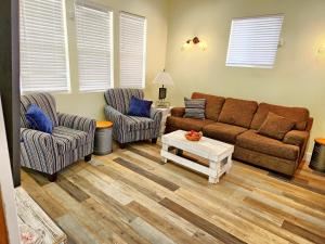 a living room with a couch and two chairs and a table at Orange Delite in Indianapolis