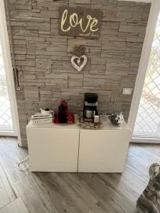 a counter in a room with a brick wall at Aria di Mare in Lido di Ostia
