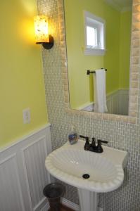 a bathroom with a sink and a mirror at Surf's Up! in Virginia Beach