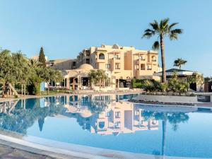 a resort with a pool in front of a building at TUISUNEO Royal Kenz in Port El Kantaoui