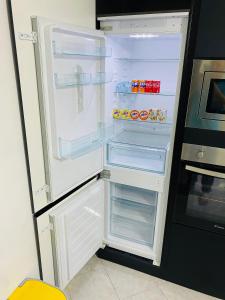 an empty refrigerator with its door open in a kitchen at The Samantha Guest House in Santo Stefano di Magra