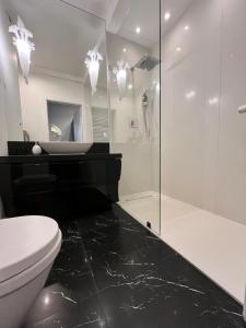 a bathroom with a toilet and a glass shower at Apartament Dmowskiego 1B Wielka Wyspa 900 steps to Market in Wrocław