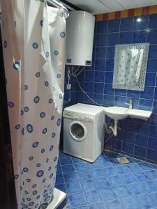 a washing machine in a bathroom with a shower curtain at Porto marina in El Alamein