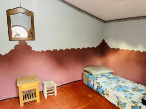 Postel nebo postele na pokoji v ubytování Auberge L'Oasis Mhamid