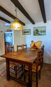 drewniany stół jadalny z krzesłami i żyrandolem w obiekcie Villa Crystal River, piscine privée & vue mer sur Golfe de Saint Tropez w mieście Saint-Peïre-sur-Mer